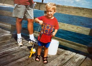 Young Eric after catching a fish from a pier in North Carolina.
