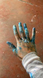 A picture of Ely's hand covered in blue paint.