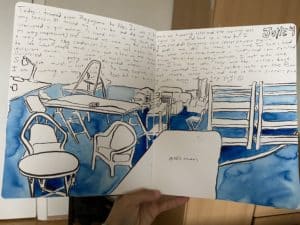 A section of Ely's sketchbook which includes a painting of the studio space and notes about her travels around Iceland