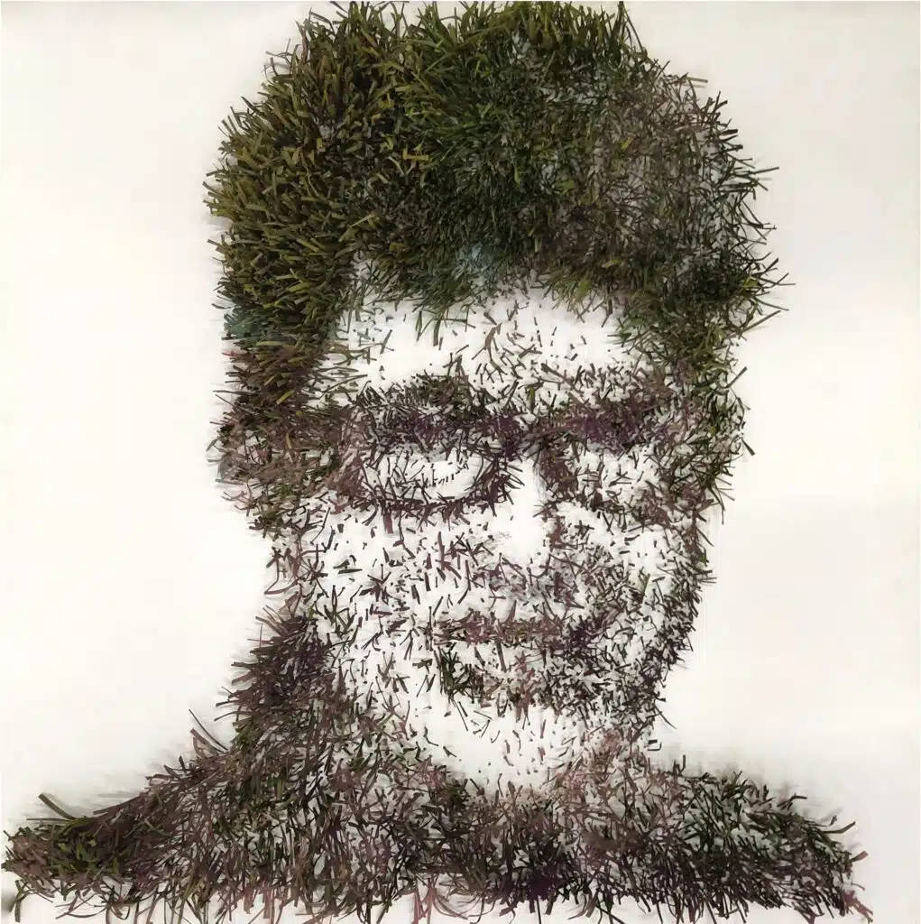 This artist used grass to create a rendition of a woman. The grass (may be fake) is made to look like it is growing out of a white piece of paper.