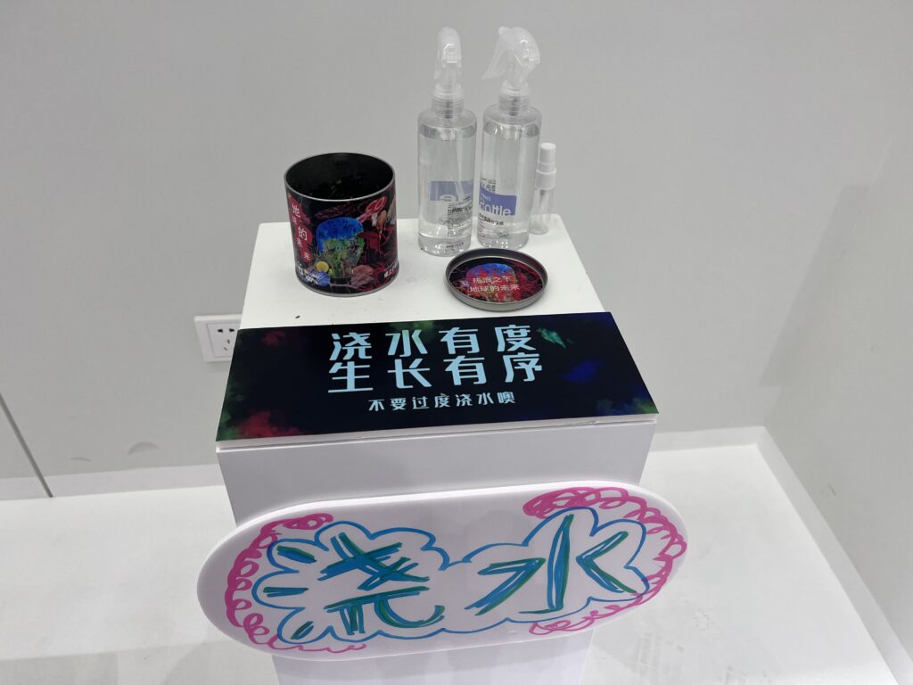 Display of hand sanitizer bottles and a small decorative tin on a pedestal with a sign featuring Chinese text.
